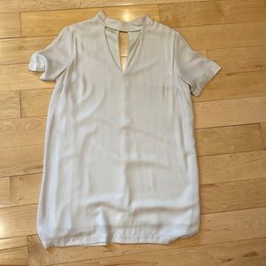 Modern, mini champagne colored sheath with cutouts at neck and back.